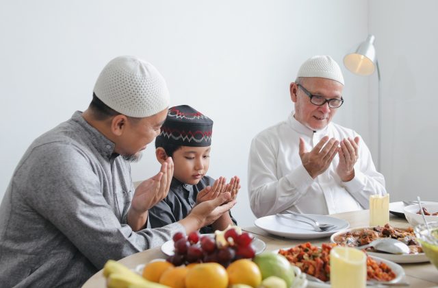 Father Teaching Son To Praying Dua Before Eating Special Dish On Eid Al Fitri Moment